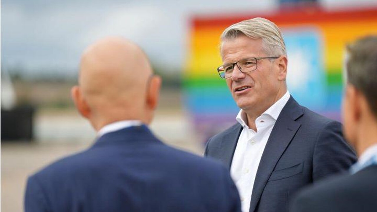 Vincent speaking with colleagues in front of Rainbow container