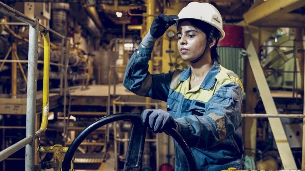 Women employee wearing blue jacket and white hat