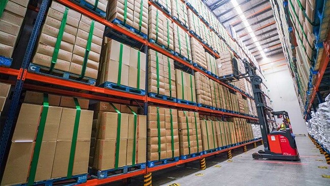A forklift truck operates in a warehouse.