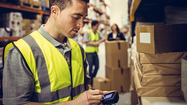 Man working in a warehouse processing ecommerce orders.
