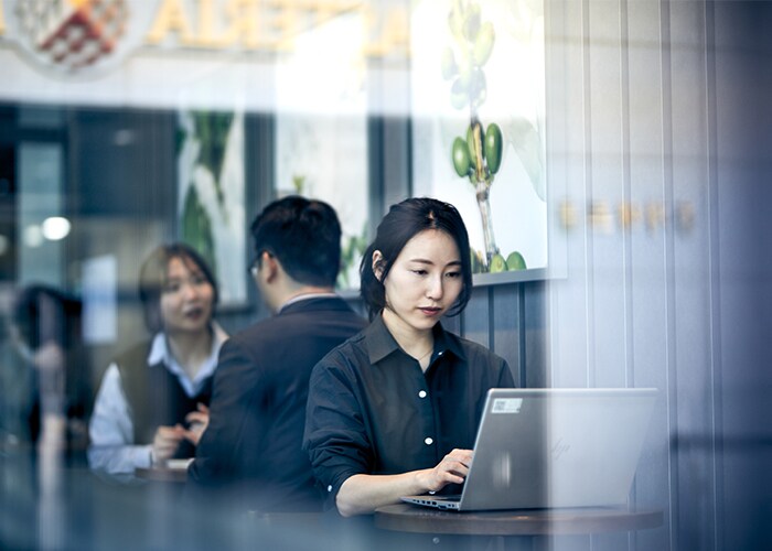 Female working on a laptop in a public space