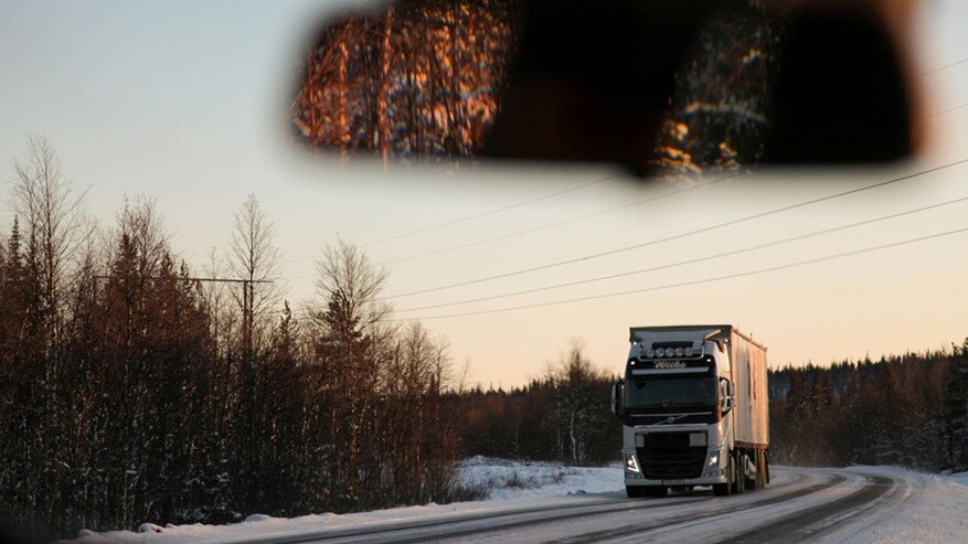 An electric truck driving down a snowy road helping decarbonising inland transportation.