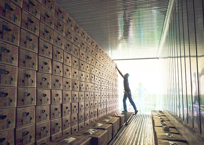 Male working on arranging the shipment boxes
