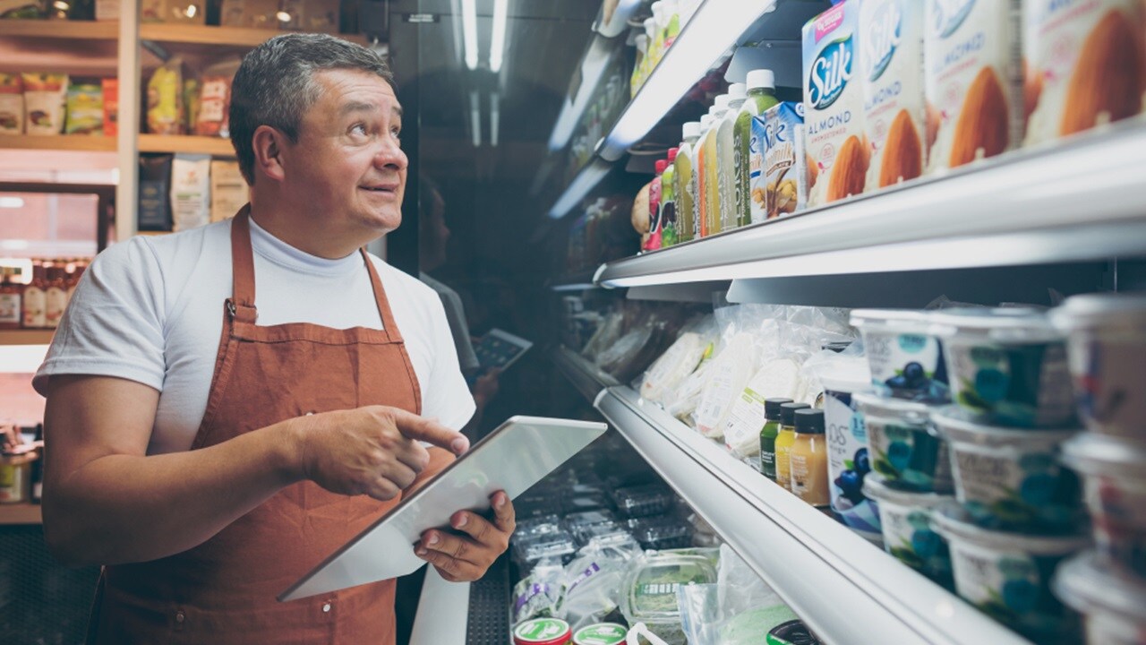 A man in a store taking stock of the goods