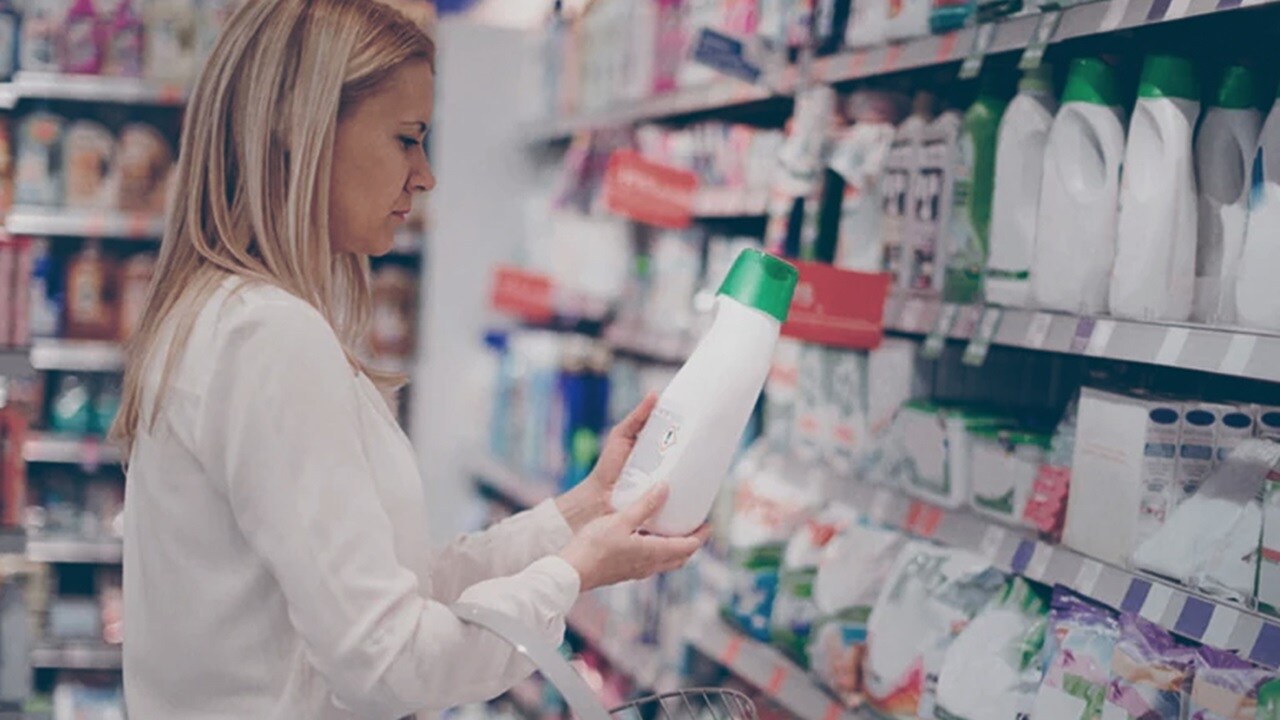 A woman in a supermarket checking products