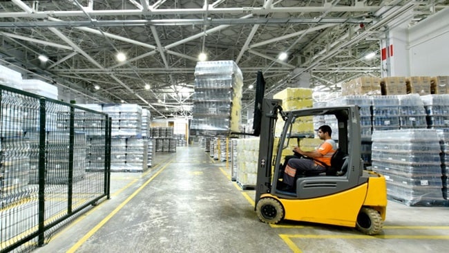 Forklift driver loading cargo shipment