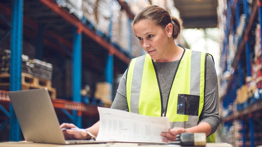 Female employee, wearing yellow safety vest