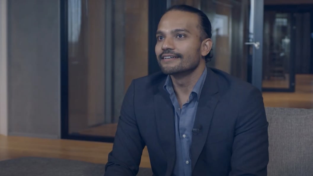 Man in a suit speaking in an office setting