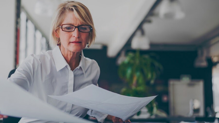 Female looking over papers in the office