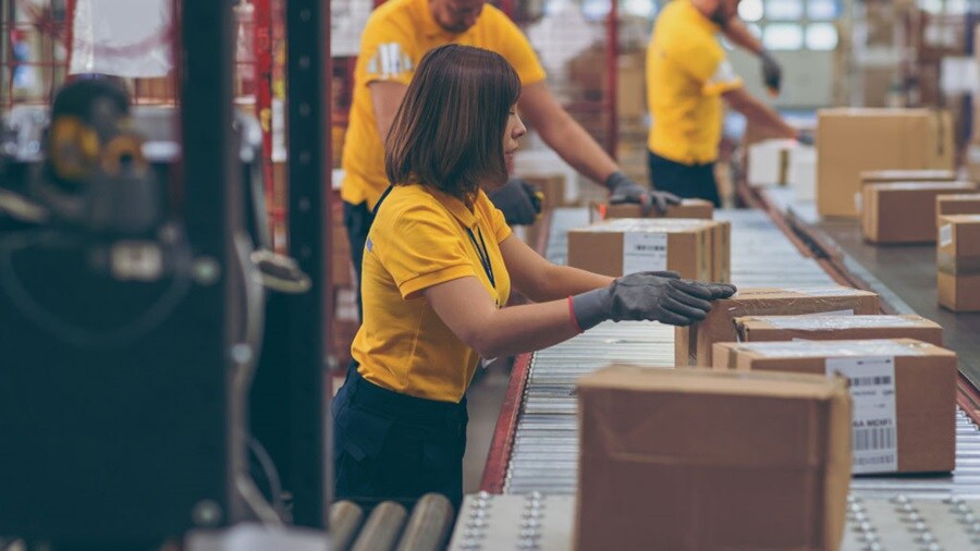 two male and a female working in the shipping office
