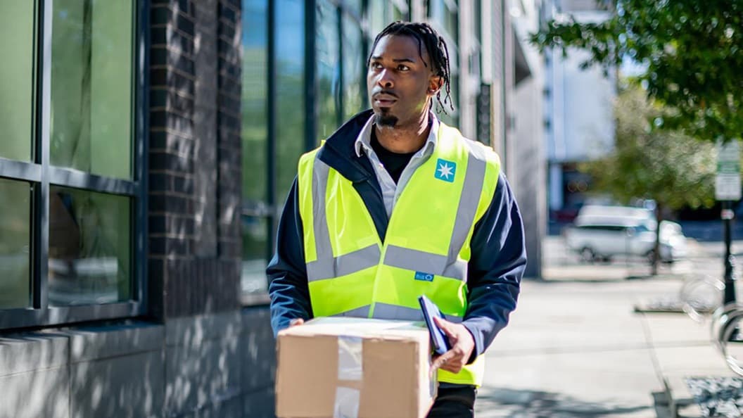 A Maersk employee delivers a package