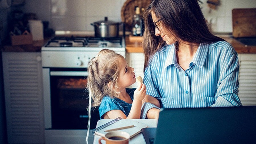Sitting woman with child and a laptop