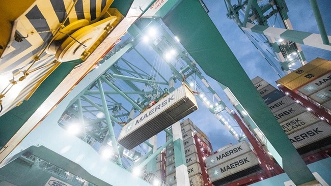 Crane is lifting a Maersk shipping container