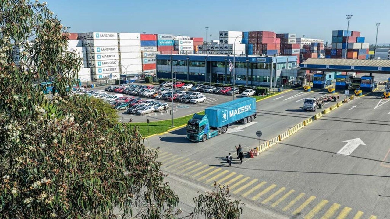 Truck with a Maersk blue container leaving the port