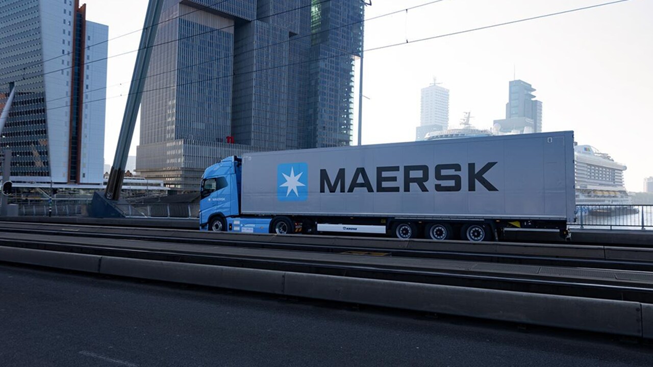 Maersk Volvo Electric truck driving over Erasmusbridge in Rotterdam.