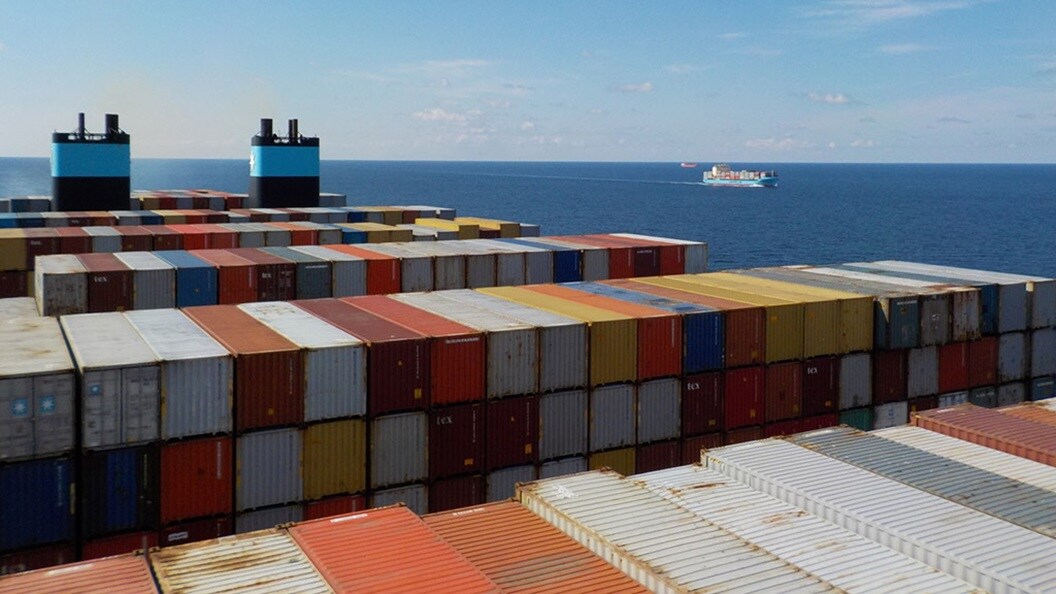 Stacked shipping containers on a Maersk container vessel at sea