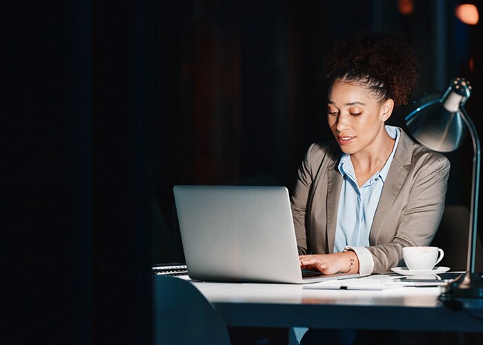 A young woman using their laptop to explore EDI solutions.