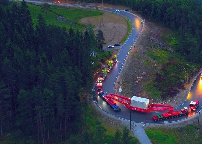 An aerial view of trucks carrying project-related cargo containers