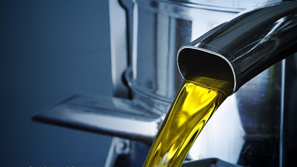 Liquid Cargo Solution | Close- up of liquid flow from metallic container.