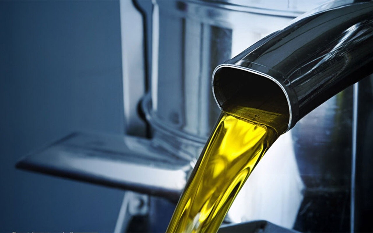 Liquid Cargo Solution | Close- up of liquid flow from metallic container.